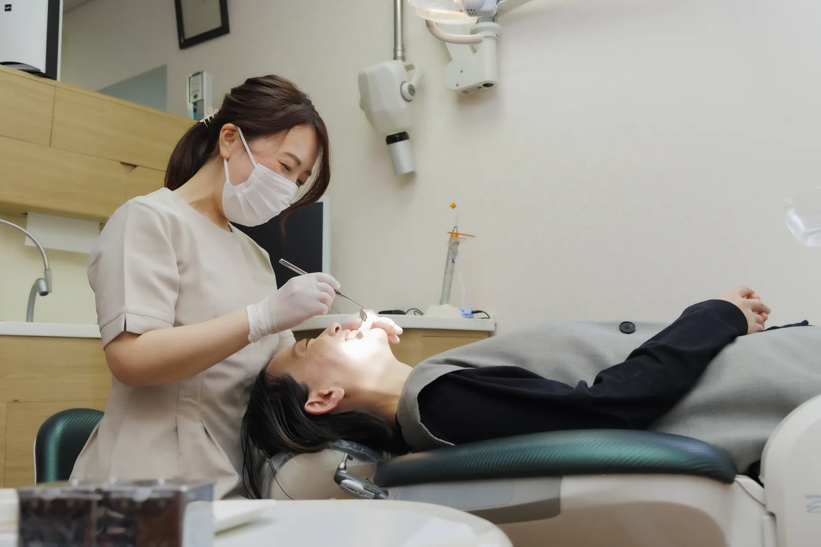 マウスピース型矯正装置とパノラマレントゲンを前に説明する歯科医師